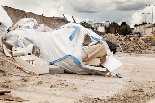 Construction site with a builders skip for waste management in Kensington