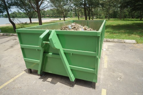 A family using a domestic skip for household waste removal